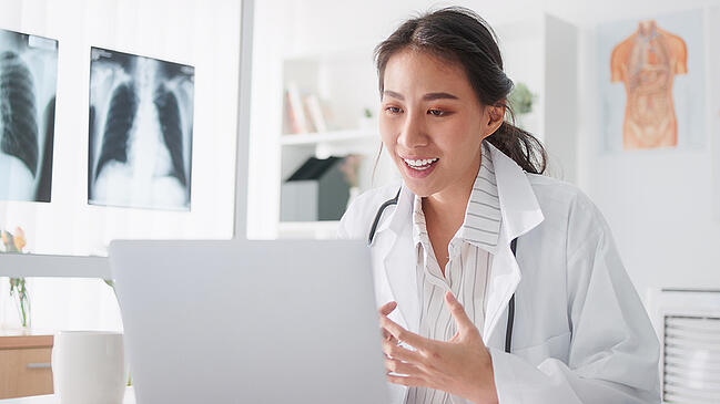Healthcare scheduler working at her computer.