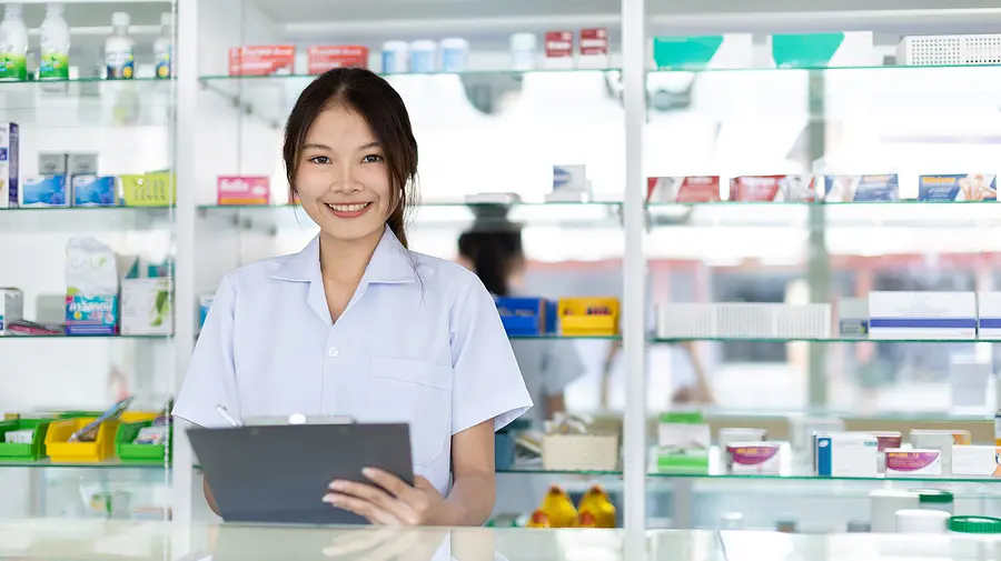 Pharmacy staff person looking over the staff schedule on a tablet