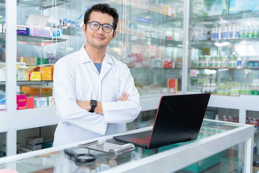 Pharmacist standing behind the pharmacy counter.