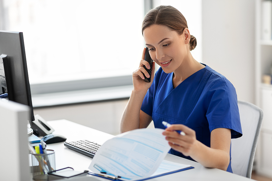 Female nurse scheduling creating a nurse staff schedule.